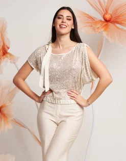 Casacca asimmetrica con paillettes e fiocco