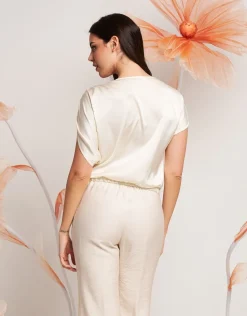 Casacca asimmetrica con paillettes e fiocco