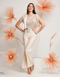 Casacca asimmetrica con paillettes e fiocco