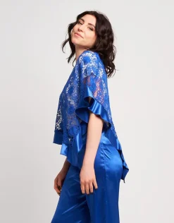 Poncho in pizzo con volants in raso