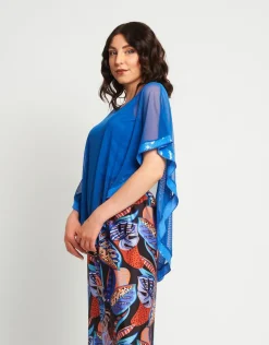 Poncho in rete con bordi in paillettes