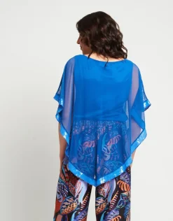 Poncho in rete con bordi in paillettes